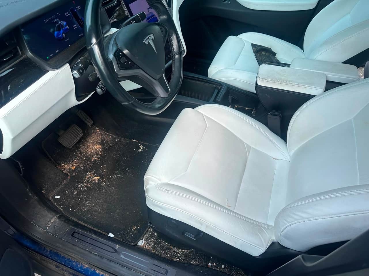 White leather SUV interior BEFORE detail — dirt and debris covering the floor mats, Flemington NJ